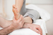 Woman having a foot massage while bending a leg