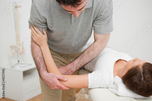 Photo: Woman lying while being massaged Woman lying while being massaged