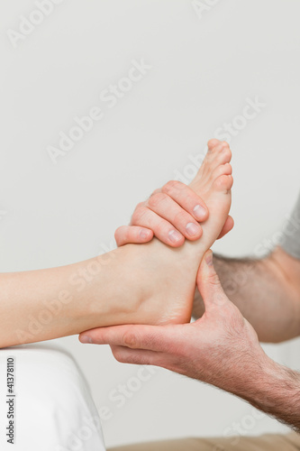 Photo: Hands of a physiotherapist massaging a foot Hands of a physiotherapist massaging a foot