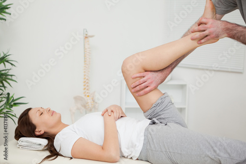Photo: Serious brunette woman lying on a medical table Serious brunette woman lying on a medical table