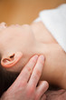 Close-up of doctor pressing two fingers on the neck of his patie
