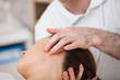 Photo: Doctor manipulating the side of the head of his patient Doctor manipulating the side of the head of his patient
