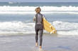 Young surfer is going to surf Young surfer is going to surf