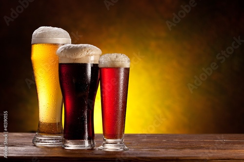 Photo: Beer barrel with beer glasses on a wooden table. Beer barrel with beer glasses on a wooden table.