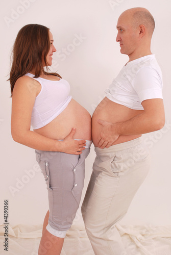 Photo: Pregnant woman belly with a man is measured Pregnant woman belly with a man is measured
