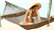 Video: Pretty woman sitting on hammock at the tropical beach Pretty woman sitting on hammock at the tropical beach