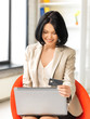 canvas print picture - happy woman with laptop computer and credit card
