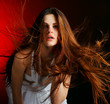 Beautiful woman with long flowing hair on a red background Beautiful woman with long flowing hair on a red background