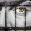 Face with green eye and painted prision