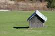 ld wooden barn in the middle of the lawn in the Dolomites
