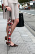 Stylish woman waiting to cross the street