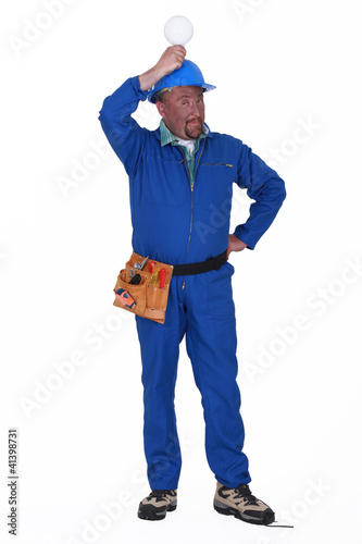 Photo: electrician holding a bulb over his head electrician holding a bulb over his head