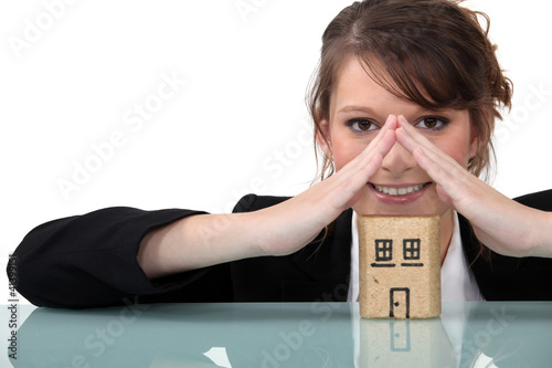 Photo: Woman with miniature model house Woman with miniature model house