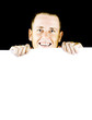 Smiling young man holding blank poster
