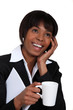 Businesswoman chatting on the phone with a hot drink