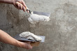 construction notched trowel and worker hands
