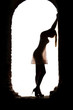 silhouette of a young  sensual woman in the window