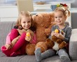 Little girls with big teddy bear smiling