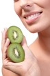 Closeup lips of smiling woman with kiwi