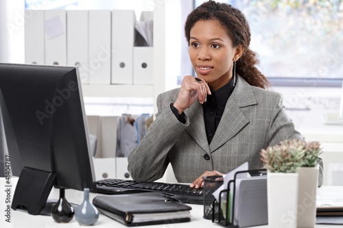 Photo: Attractive businesswoman working in office Attractive businesswoman working in office