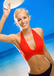 Young woman playing with flying disc