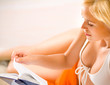 Woman reading book on beach