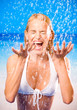 Young woman at rain or summer shower on beach Young woman at rain or summer shower on beach