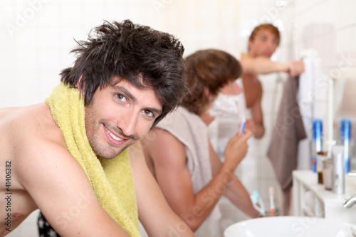 Photo: Handsome young man getting ready with his mates Handsome young man getting ready with his mates
