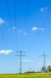 high-voltage line in yellow field high-voltage line in yellow field