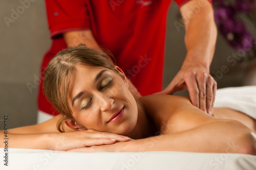 Photo: Woman enjoying wellness back massage Woman enjoying wellness back massage