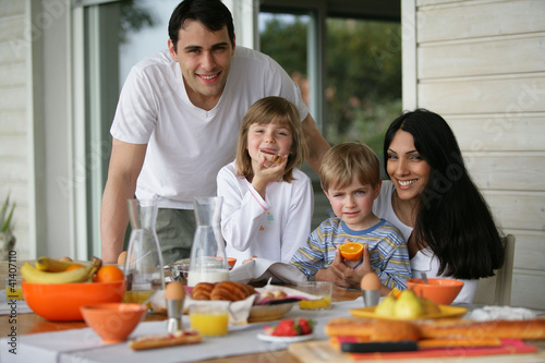 Photo: Family having breakfast outdoors Family having breakfast outdoors