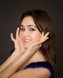 Portrait of beautiful young brunette woman propping up her face