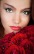 woman with a bouquet of red roses