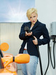 canvas print picture - Woman has fun to load electrically powered car outdoors