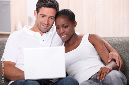 Photo: Couple watching DVD on laptop Couple watching DVD on laptop