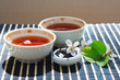 Two cups of tea, jar of tea leaves and cherry blossoms
