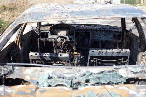 Photo: Burned out car in street Burned out car in street