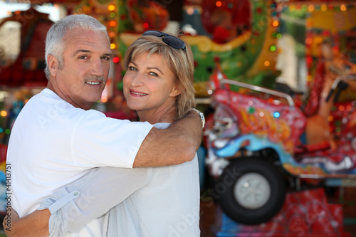 Photo: Middle-aged couple at funfair Middle-aged couple at funfair