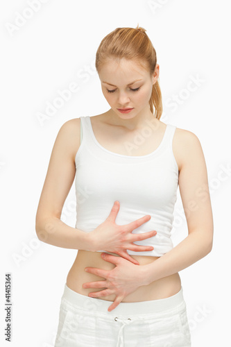Photo: Woman placing her hands on her stomach Woman placing her hands on her stomach