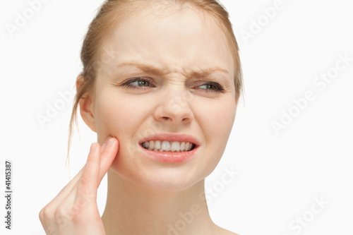 Foto: Woman massaging her cheek Woman massaging her cheek