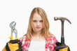 Photo: Serious woman holding a hammer and and a wrench Serious woman holding a hammer and and a wrench