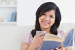 Woman with a mug and a book in her hands