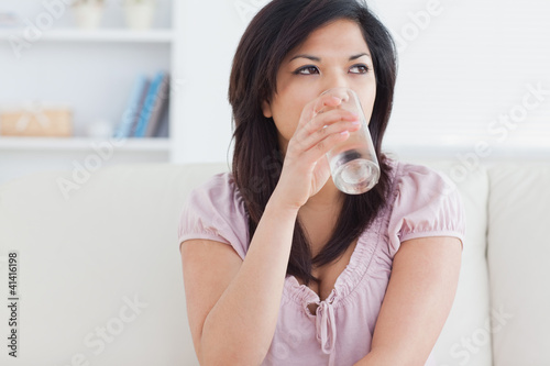 Foto: Woman drinking from a glass of water Woman drinking from a glass of water