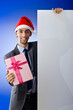 Businessman in santa hat with blank message Businessman in santa hat with blank message