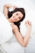 Smiling woman lying while stretching her body