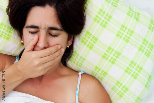 Photo: Hispanic woman feeling coughing or feeling nausea Hispanic woman feeling coughing or feeling nausea