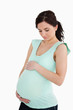 Young pregnant woman looking at her belly Young pregnant woman looking at her belly