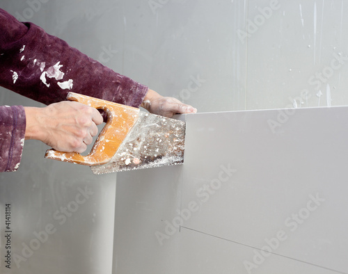 Photo: cutting plasterboard plaster hand dirty saw cutting plasterboard plaster hand dirty saw
