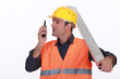Labourer speaking into a walkie-talkie