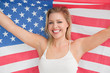 Smiling woman raising the American flag